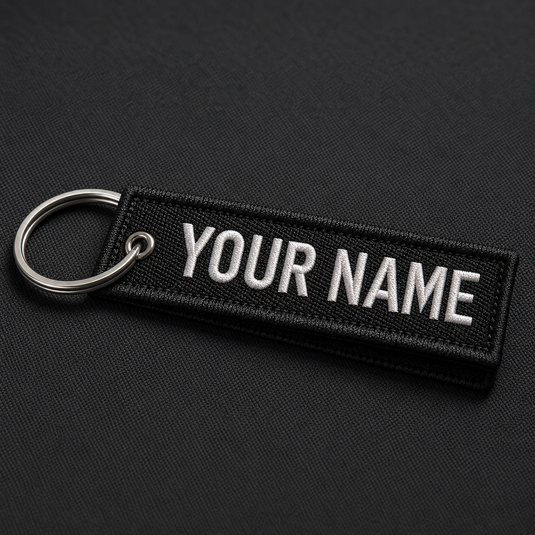Black personalised embroidered flight tag keyring with white YOUR NAME text